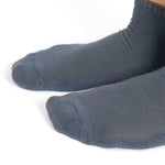 Close-up of dark blue bamboo socks on feet