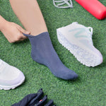 Dark blue bamboo sock being worn on grass