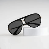 Solar Surge Shade sunglasses on white stand, bright background