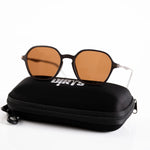 Dark brown sunglasses with amber lenses on case