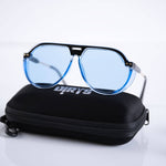 Blue-lensed Arctic Aura Shade sunglasses on branded case